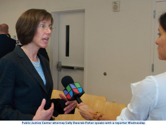 Public Justice Center attorney Sally Dworak-Fisher speaks with a reporter Wednesday.